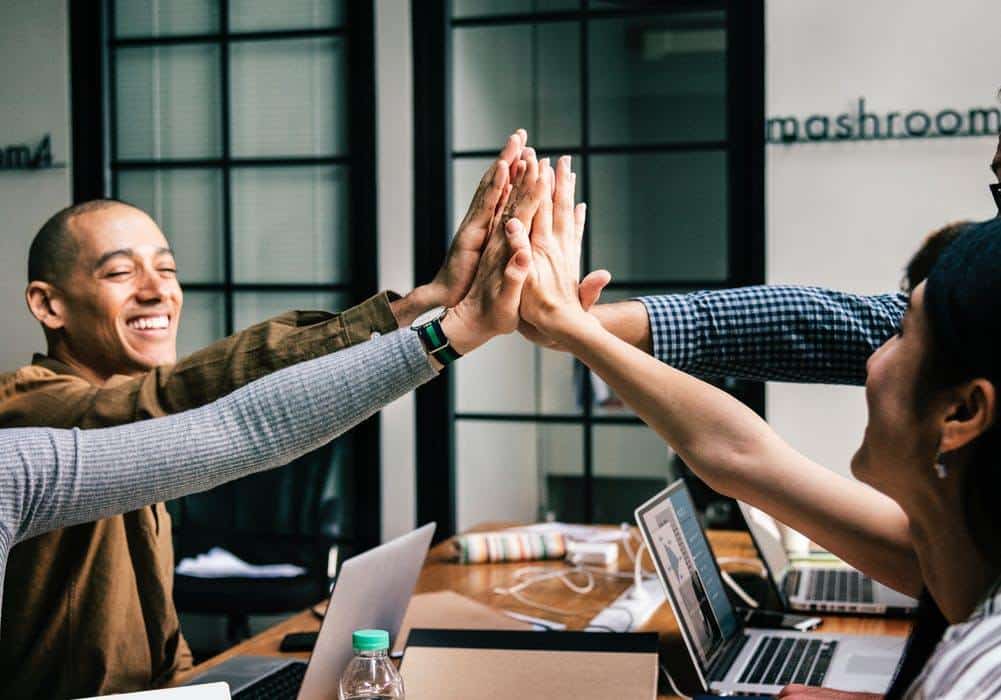 a group of people giving each other a high five