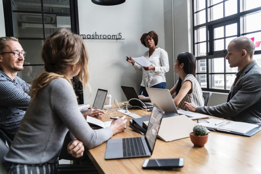 diverse professionals collaborate in a bright modern office, sharing ideas and technology insights.