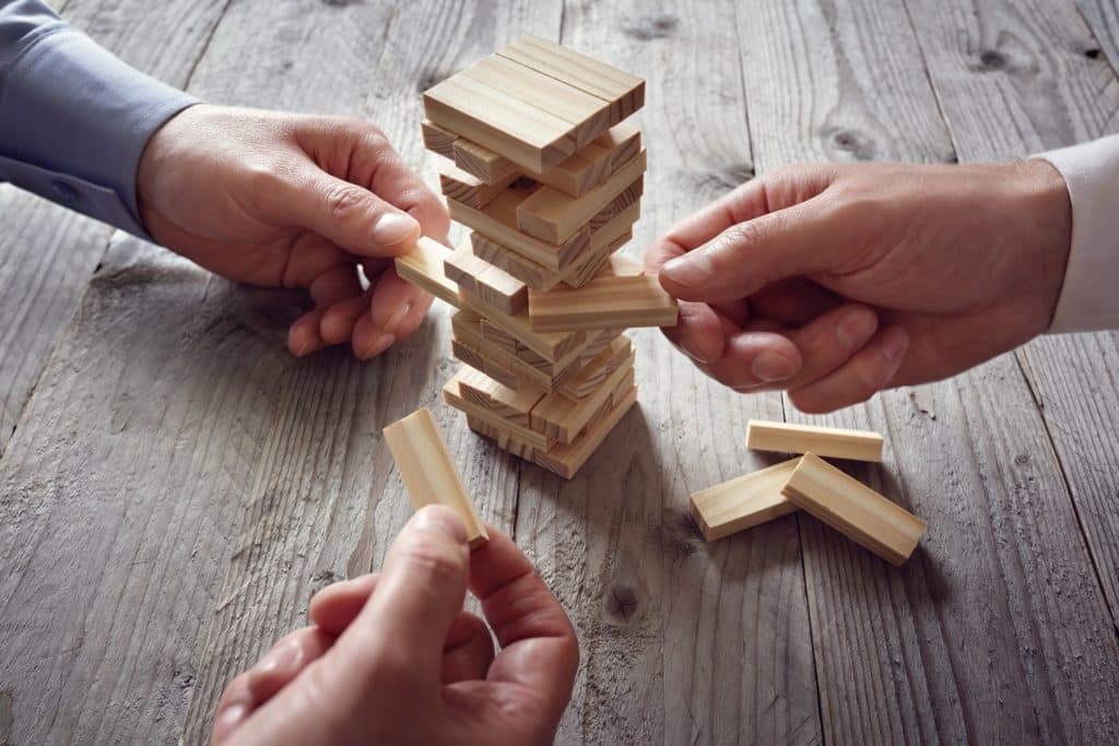 intense jenga game moment with friends, showcasing skillful play and a precarious tower.