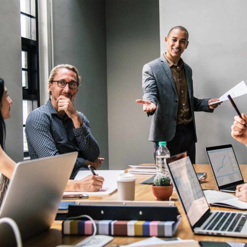 diverse professionals engage in a collaborative meeting in a bright, modern conference room.