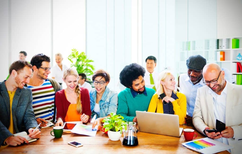 a group of people sitting around a wooden table