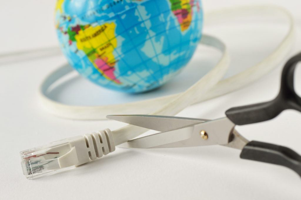 a pair of scissors sitting next to a globe