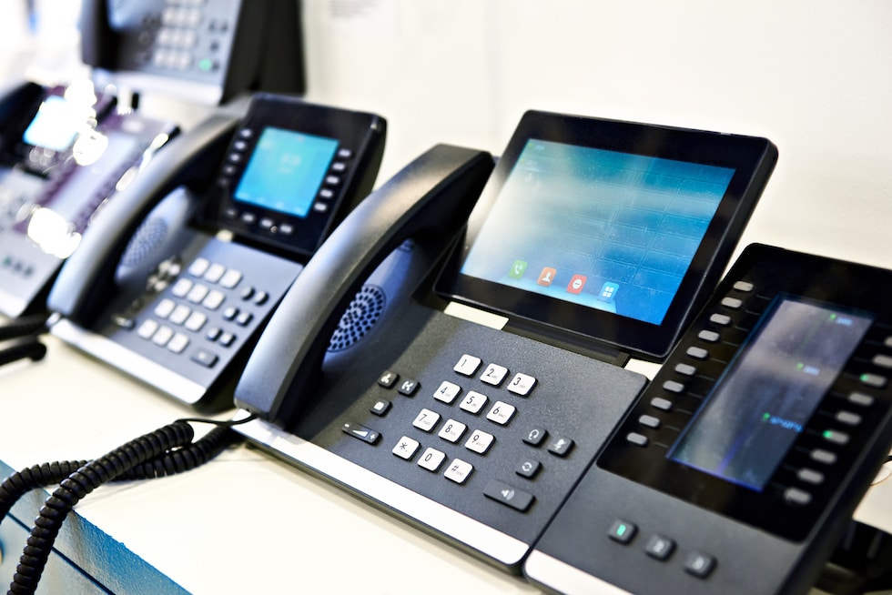 a row of phones sitting on top of a table