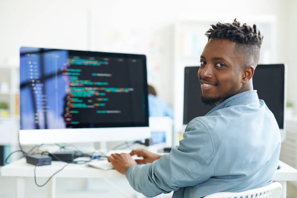 a man sitting in a chair in front of a computer