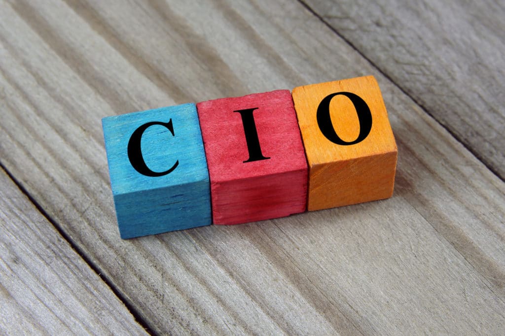 wooden blocks spelling the word cio on a wooden surface