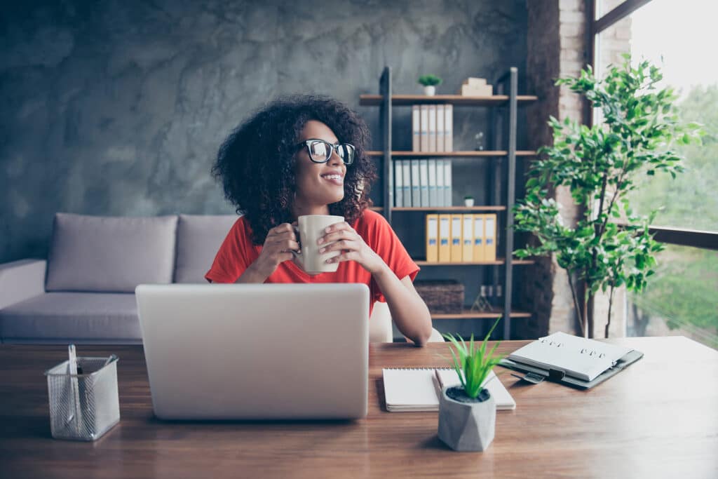 a woman sitting at a table with a laptop