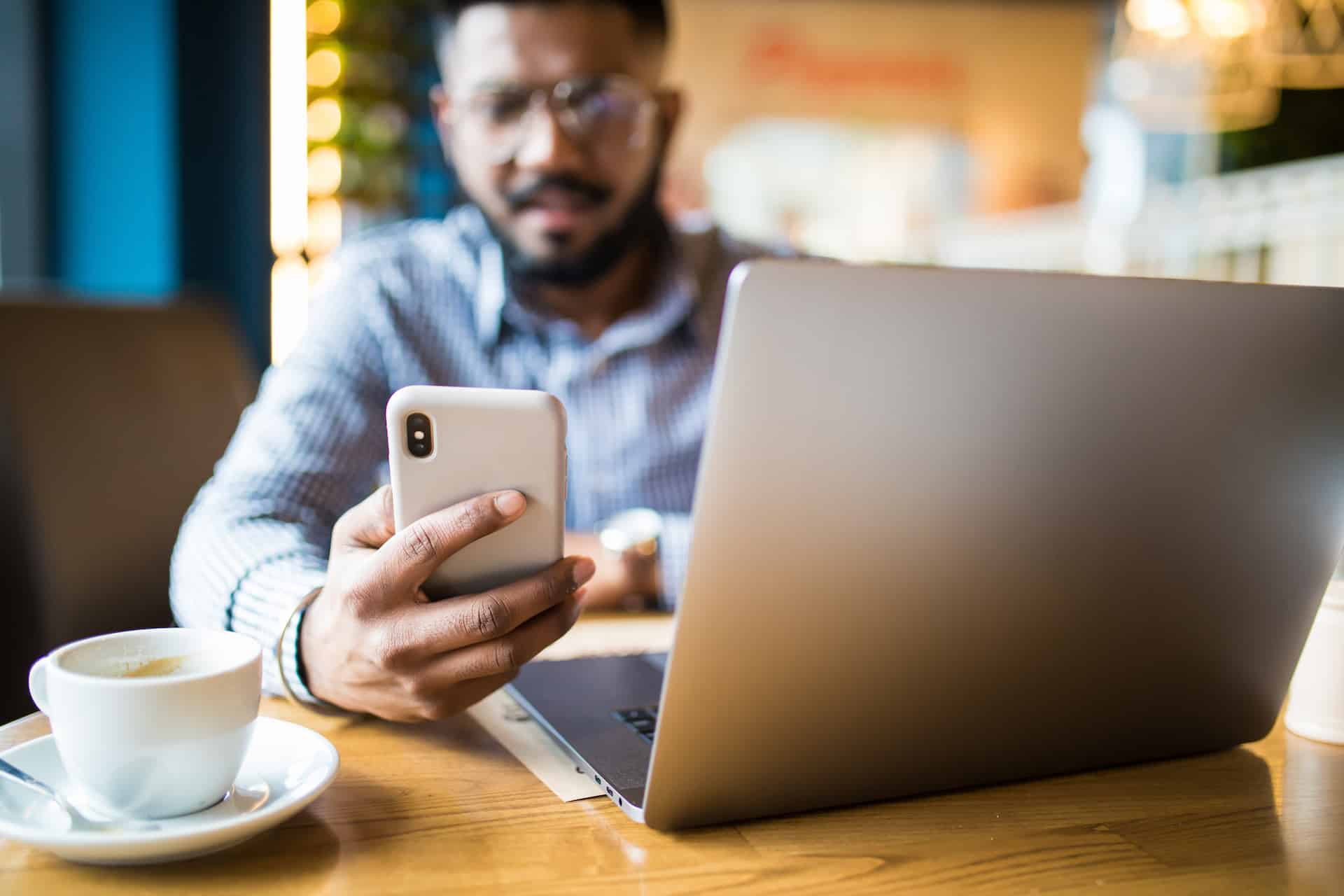 a man sitting in front of a laptop computer